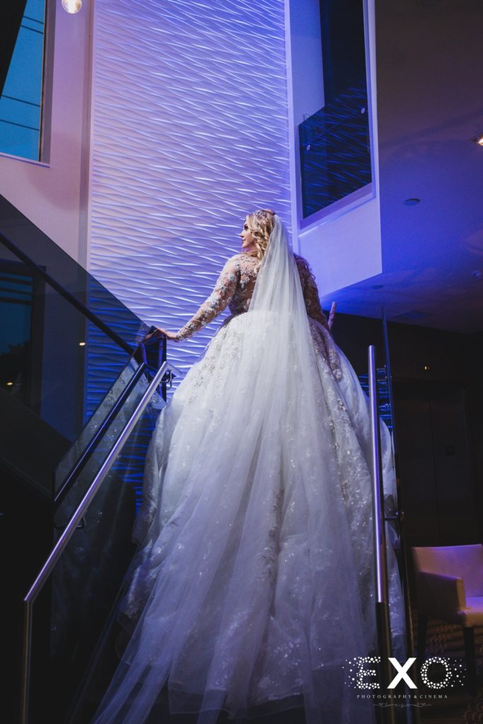 bride back of dress walking up stairs