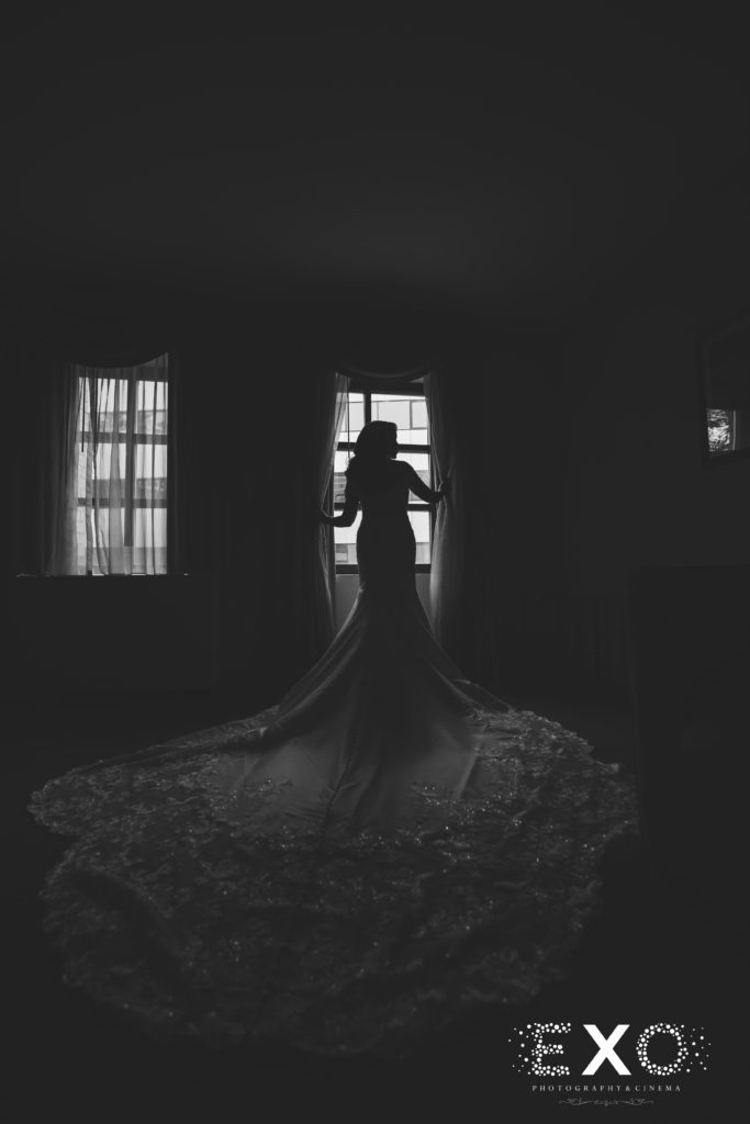 bride in front of window back of dress