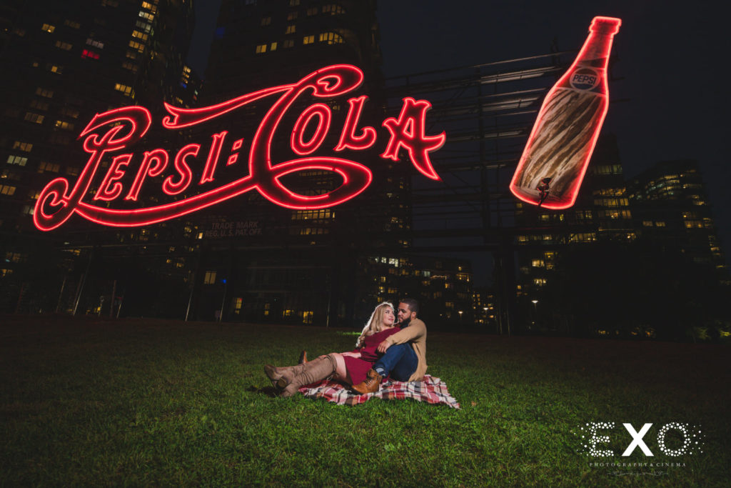 Gantry Park engagement session with the couple in-front of the Pepsi cola sign
