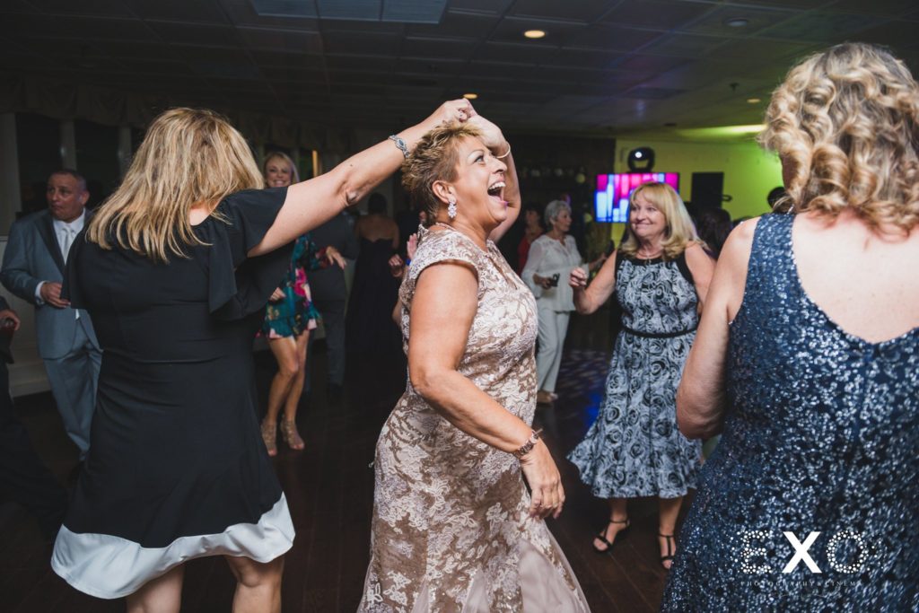 mom and friend dancing at wedding