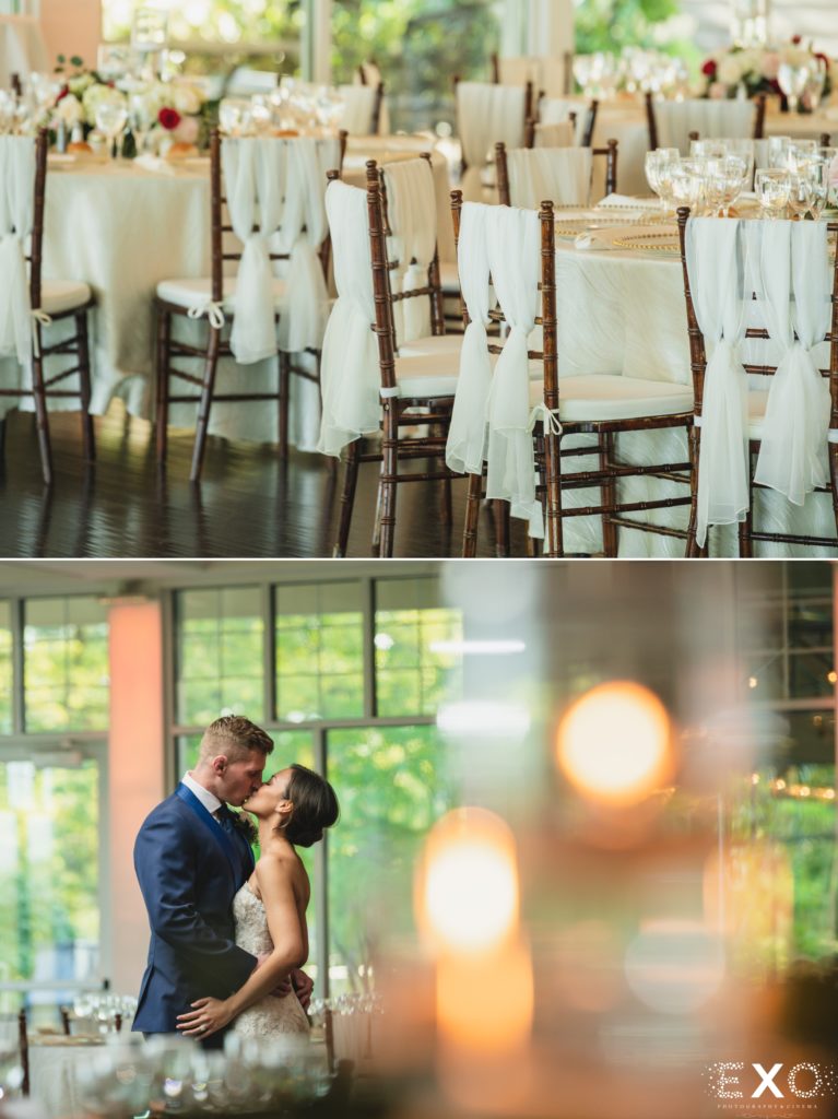 Reception tables, bride and groom kissing.