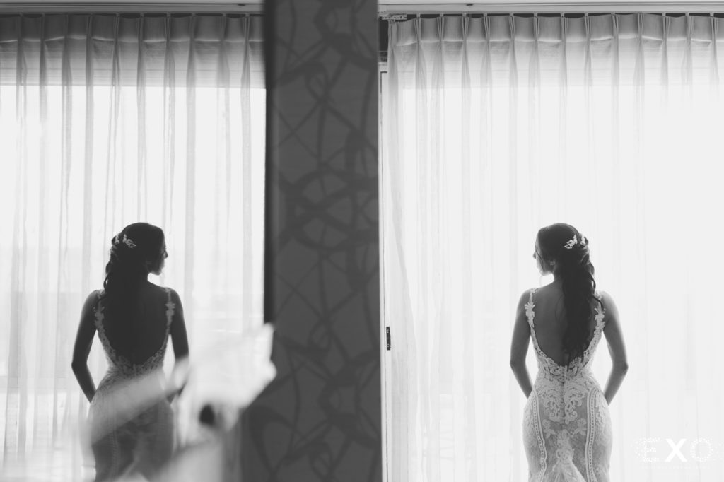 Bride looking out of a window.