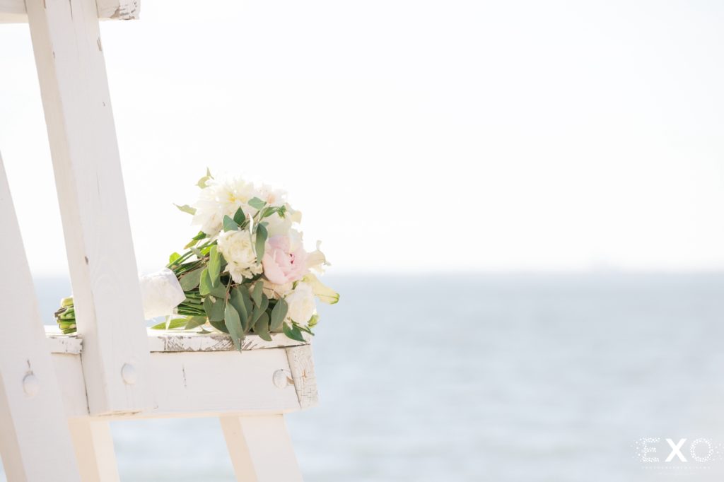 Lifeguard chair with bouquet of flowers on it,