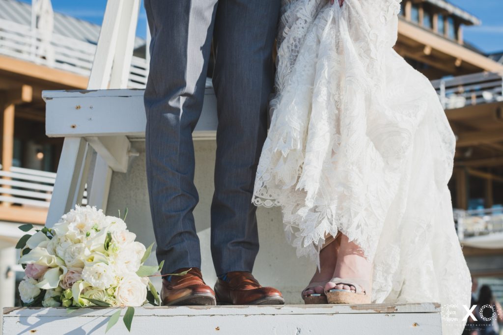 Bride and grooms shoes with flowers.