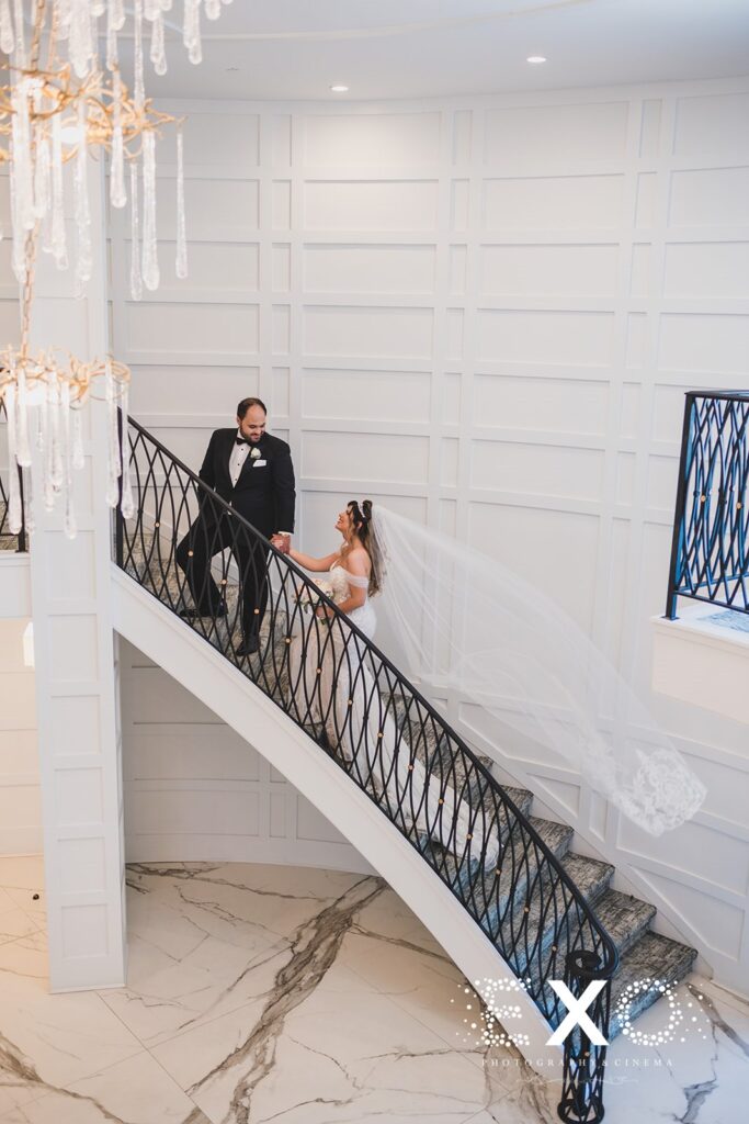 Waters Edge wedding photo shot on lobby stairway of bride and groom on their wed day