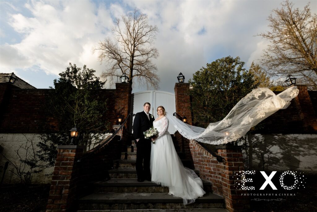 fox hollow wedding photo with darby and sean by the gate