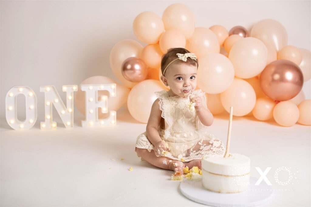 Baby girl eating cake at her cake smash photos