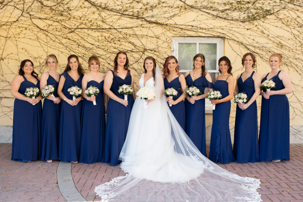 Bridesmaids wearing blue dresses at Mansion at Oyster Bay wedding