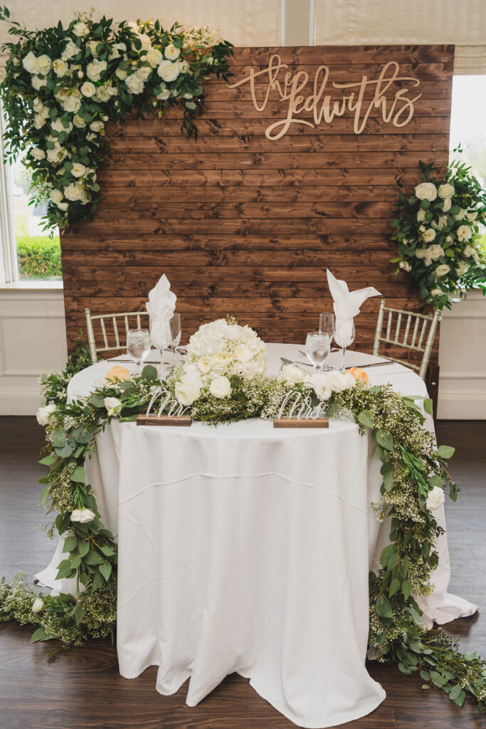 Bride and groom table with a garland