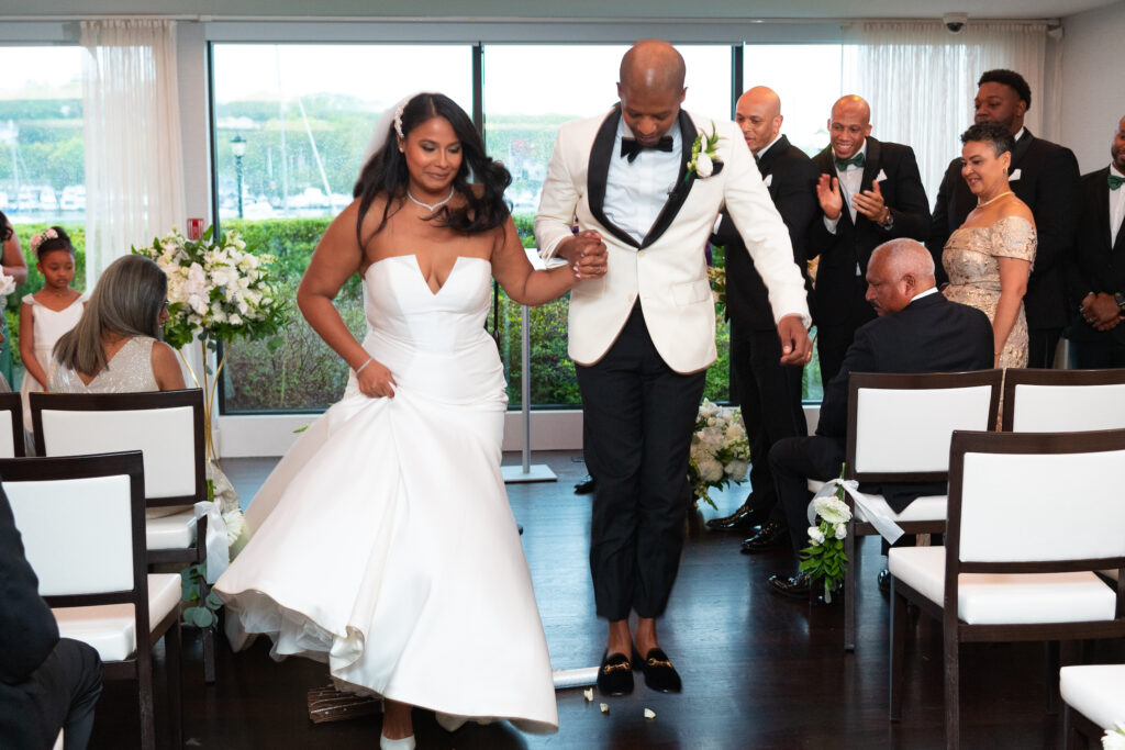Bride and groom jumping the broom