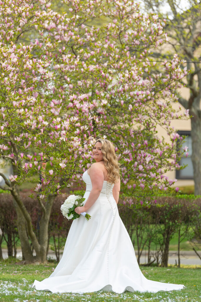 Bride in front of a cherry blossom tree