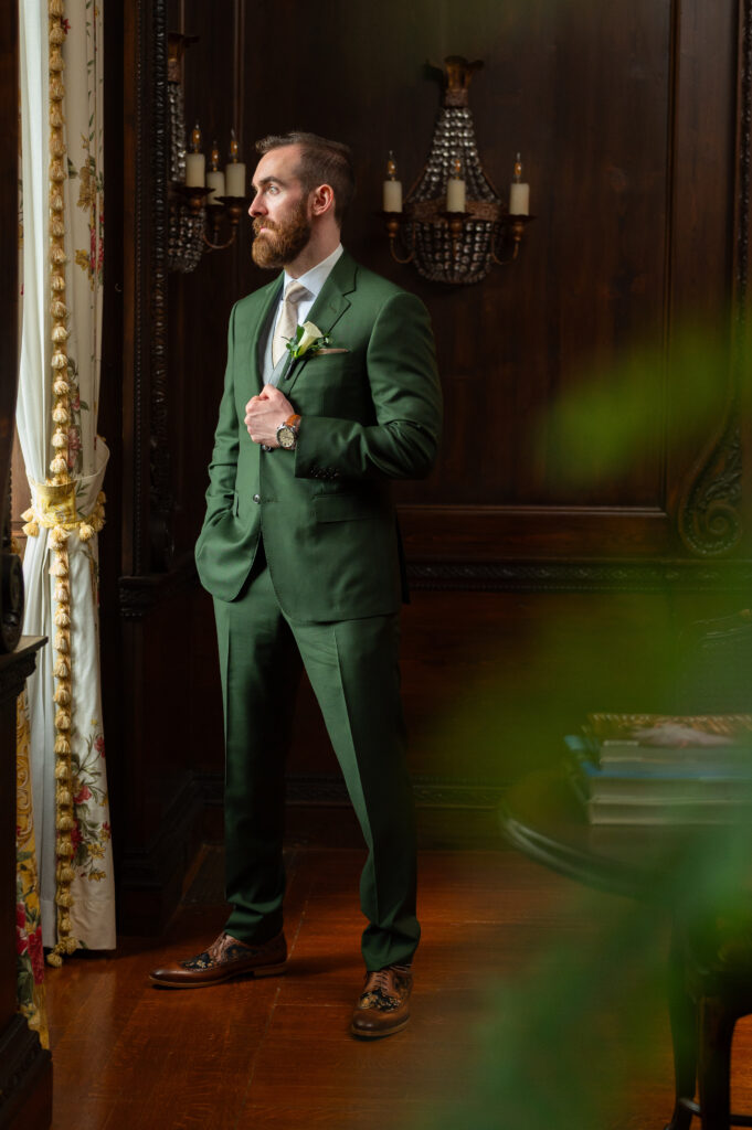 The Woodside Club groom prep wearing green suit