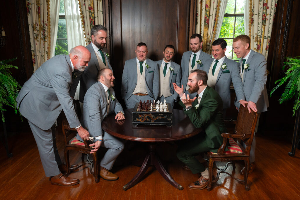 The Woodside Club groomsmen playing chess