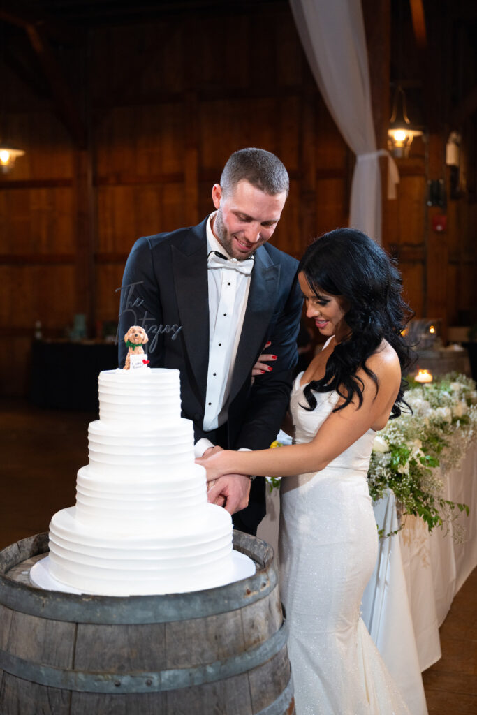 Bride and groom cutting the cake at The Barn at Old Bethpage