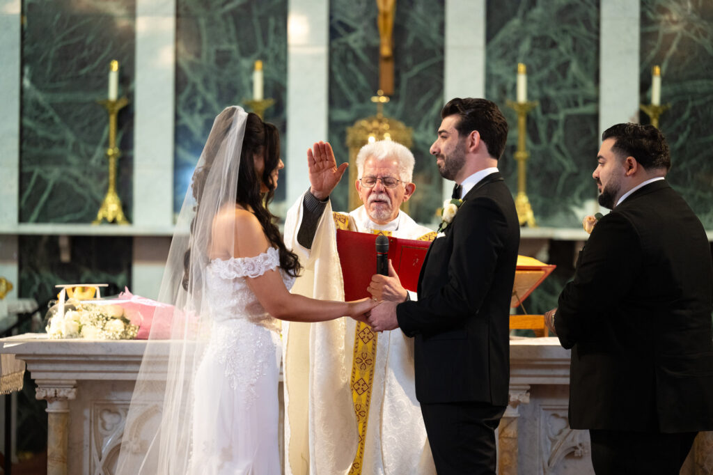 Priest blessing the couple