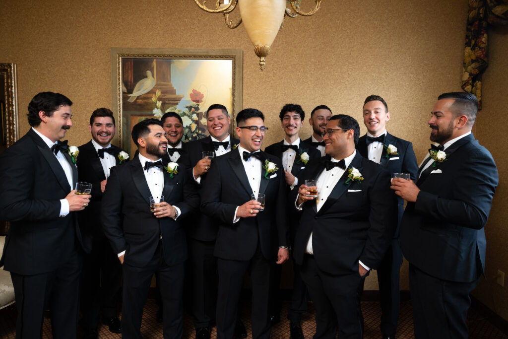 Candid wedding photo of groom and groomsmen