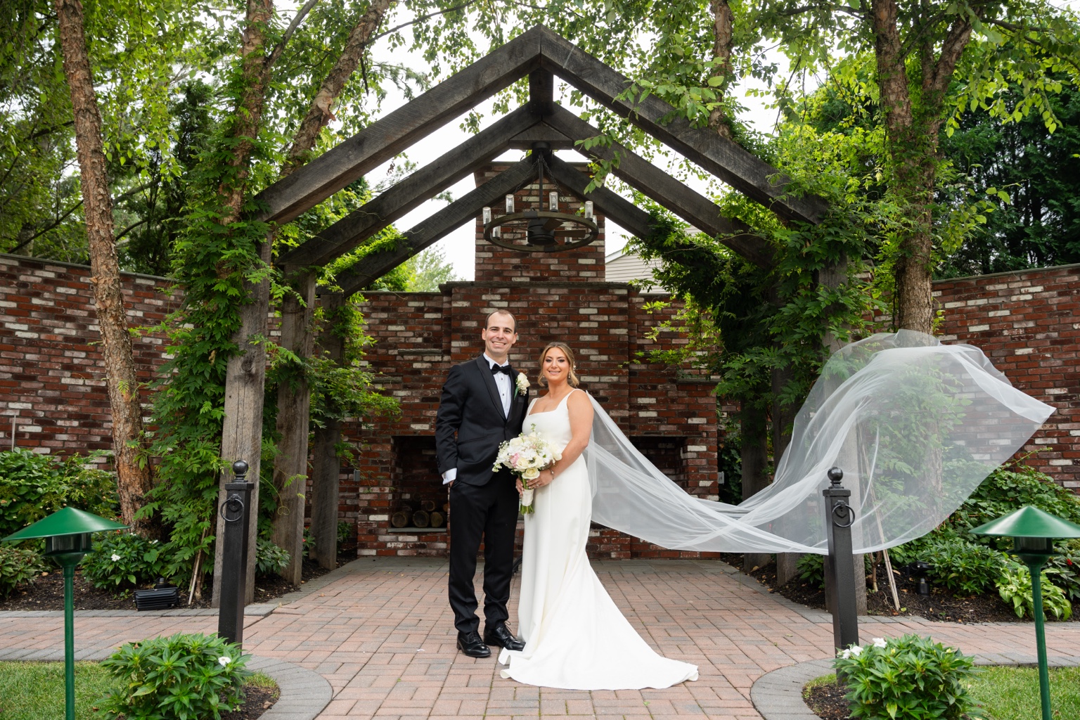 Wedding couple at Stewart Manor Country Club garden ceremony setting