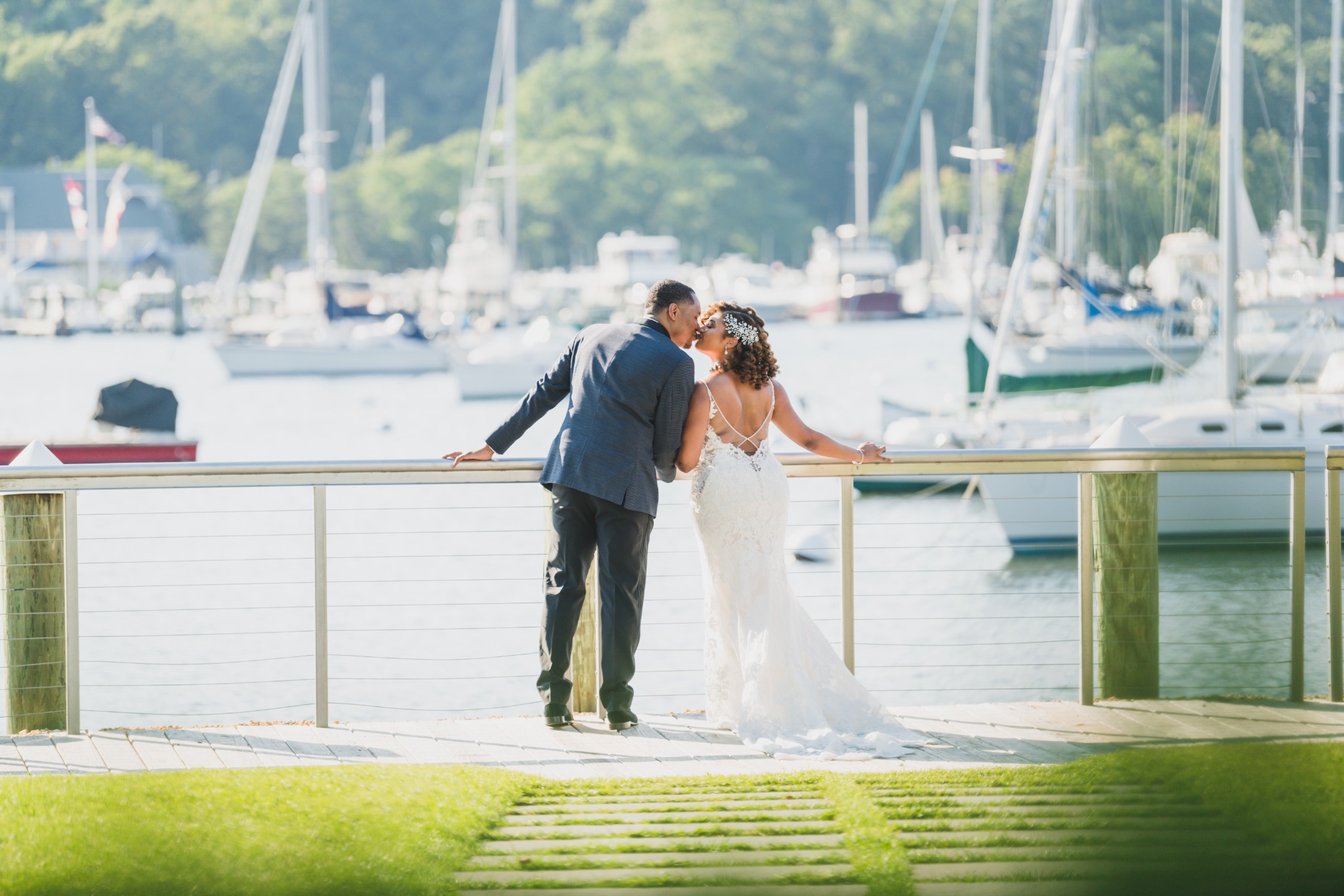 Bride and groom at the marina railing overlooking the boats