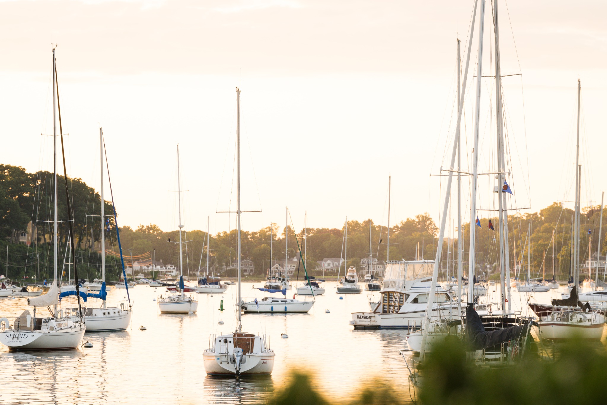 Sailboats on Huntington harbor in the warm light of sunset