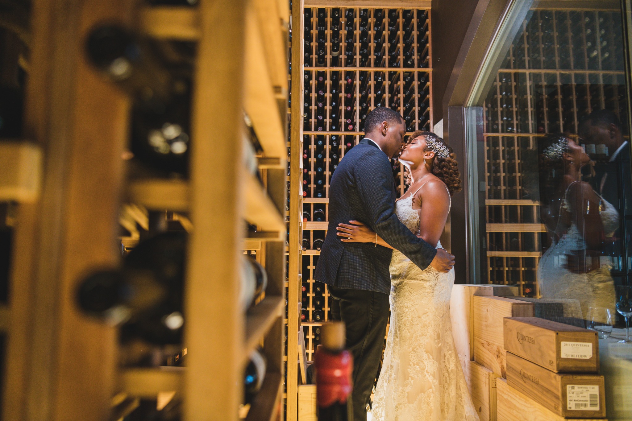 Couple kissing indoors in a wine cellar portrait